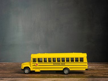 school bus on wood table for back to school or education concept