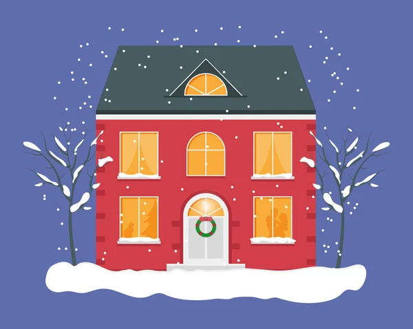 Karlı kış gecesi. Noel zamanı. Işıklı pencereli kırmızı ev