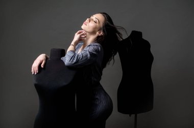 Genç kız model, moda tasarımcısı ofisindeki hayalleri mankenlere dayanıyor.
