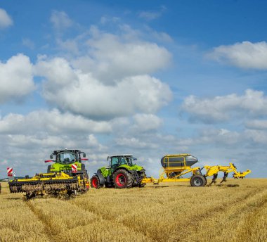tractors with harrows and at the demonstration of agricultural machinery at the exhibition