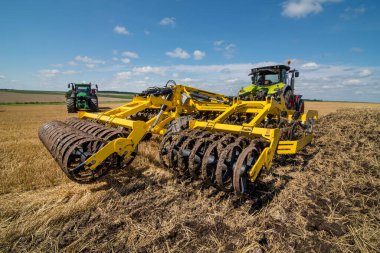 multi-disc cultivator, tillage system in operation with tractor