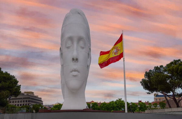 Madrid, Spain - 2019 . Spanish flag and Julia sculpture by artist