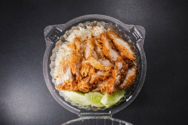 Chicken fried rice in plastic food box with top view clipart