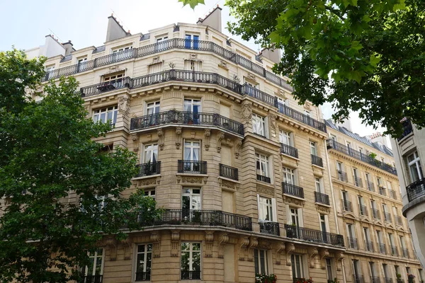 The facades of traditional French houses with typical balconies and windows. Paris, France.