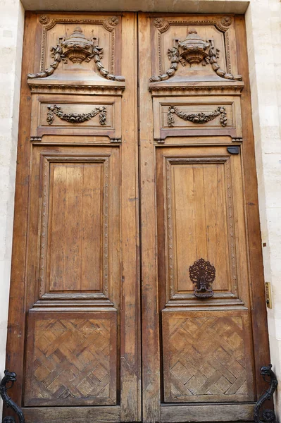 Old ornate door in Paris, France - typical old apartment building.