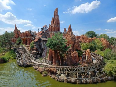 The fantastic roller coaster at the amusement park lake.