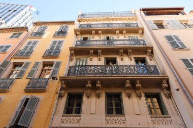 Looking up at the architectural details of an old apartment building in Toulon, France. Beautiful arches, moldings and juliet balconies.