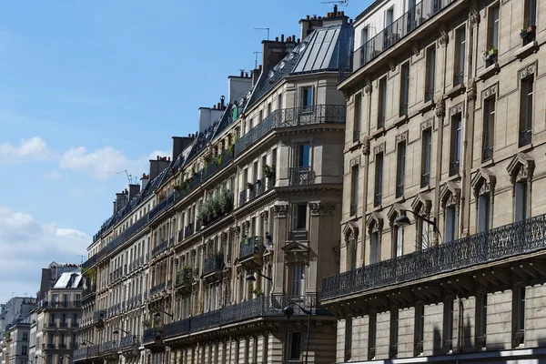 The facades of traditional French houses with typical balconies and windows. Paris, France.