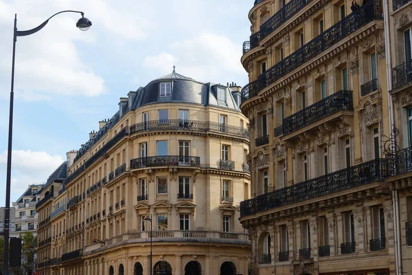 The facades of traditional French houses with typical balconies and windows. Paris, France.