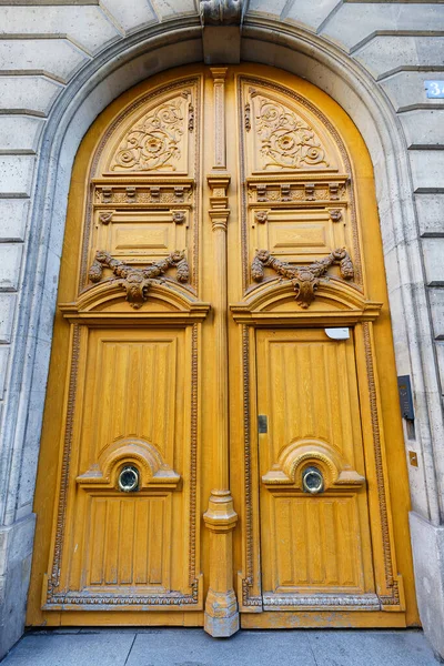 Old ornate door in Paris, France - typical old apartment building.