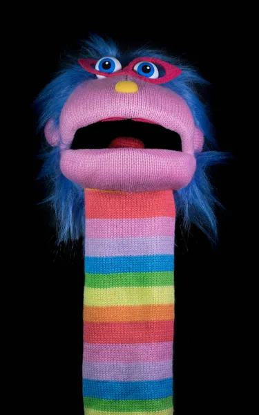 Sock Puppet Isolated Against Black Background