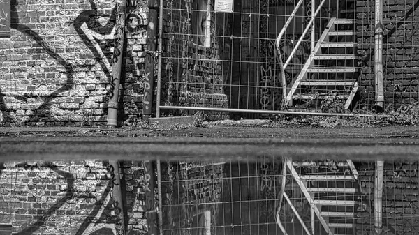 Street Photo Graffiti Wall Construction Fence Reflected Puddle Lots Texture — Stock Photo, Image