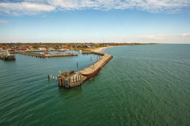 View from the departing ship over the Rostock harbor in Warnemuende. Sunshine and calm Baltic Sea during the crossing to Scandinavia