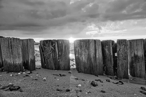 Black White Groynes Jutting Sea Sunset Beach Stones Foreground Taken — Stok fotoğraf