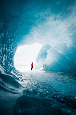 Person is standing in beautiful ice cave in Vatnajkull glacier Iceland in the winter clipart