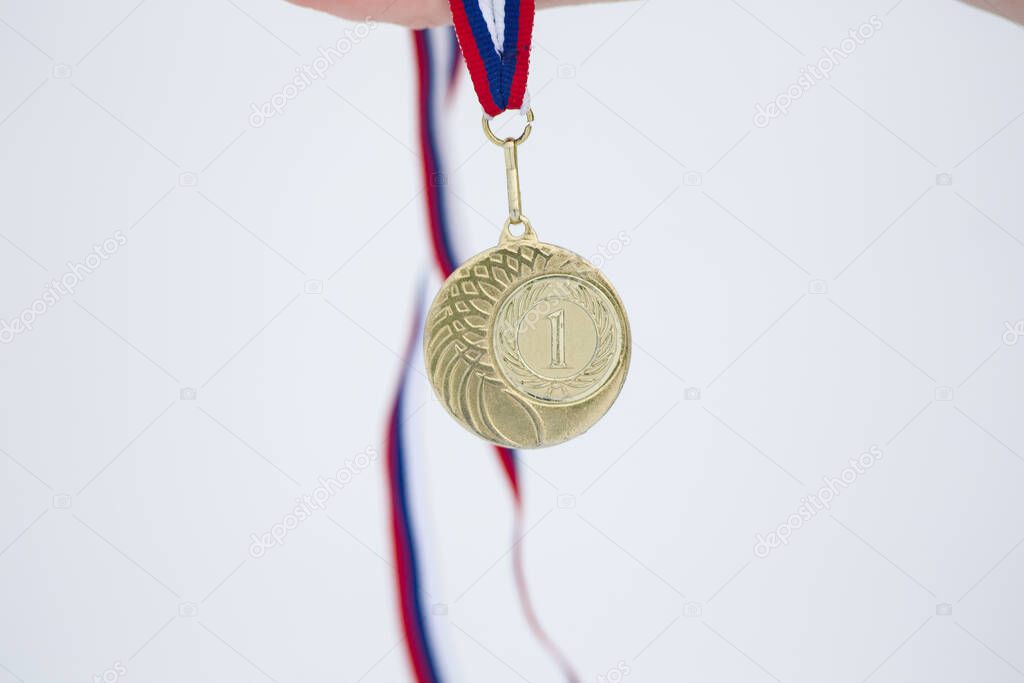 Gold medal in snow white background for winners in winter games 