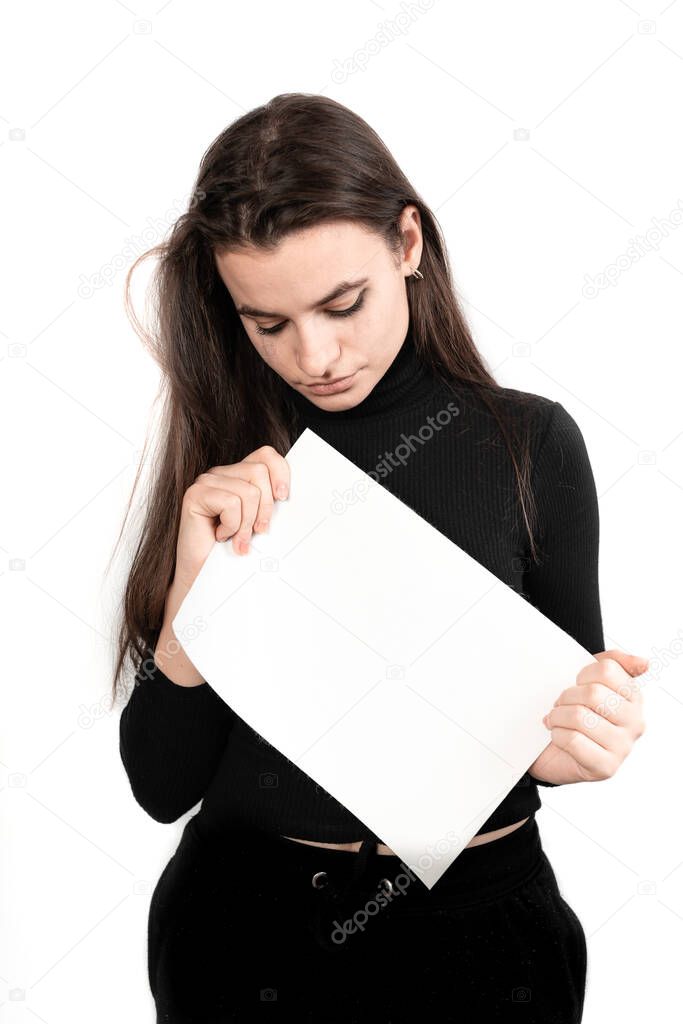 Beautiful brown-haired girl holds a white board in her hand, the girl is crying and sad, tears are running down her face, depression, violence, her okay not to be okey, useful for background