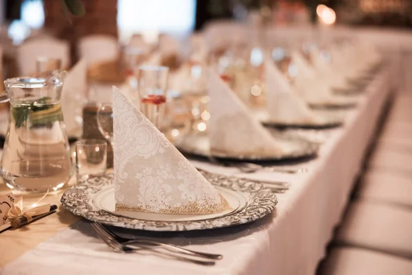 Beautiful wedding room with wedding table with food, flowers and drinks, decorations,lights everywhere