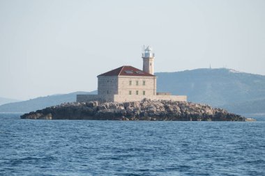 building of a lighthouse at a small rocky island in sea