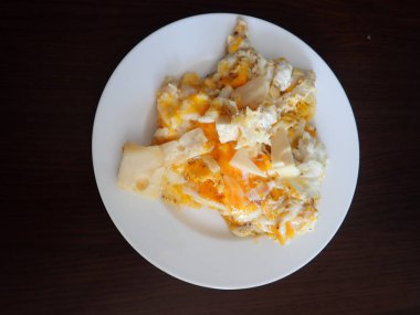 scrabbled eggs with vegetales served on a plate for breakfast