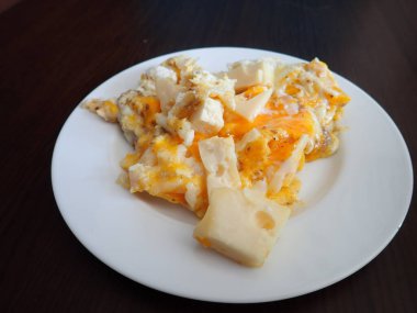 scrabbled eggs with vegetales served on a plate for breakfast