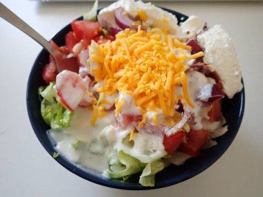 served bowl od a fresh vegetable salad with cheese
