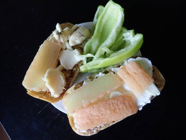 bread with cheese and vegetables snack served on a plate