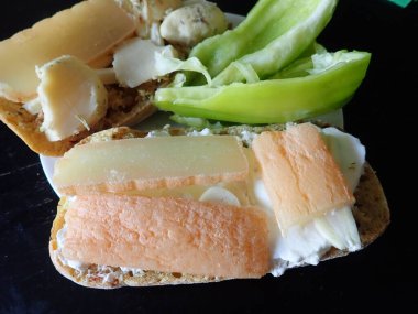 bread with cheese and vegetables snack served on a plate