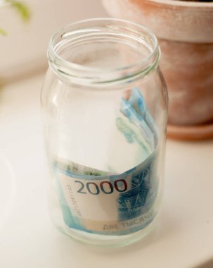 Cam bir kavanozdaki bulanık kenarlı ruble banknotları.