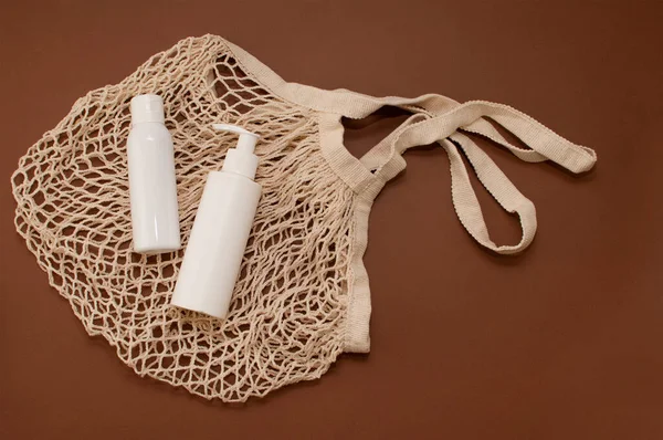 Λευκά Μπουκάλια Καλλυντικών Μια Τσάντα String Καφέ Φόντο Μια Θέση Royalty Free Εικόνες Αρχείου
