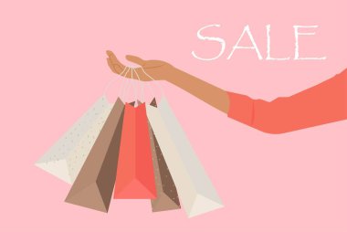 A woman's hand holding shopping bags sale