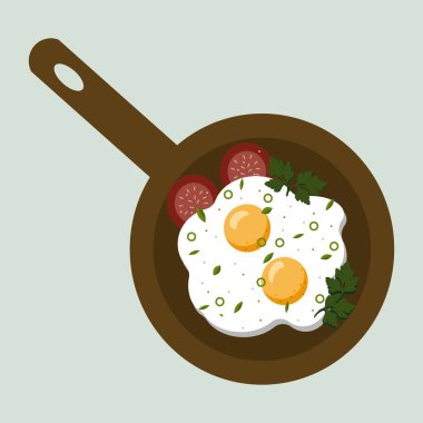 Tavada yumurta ve domates dilimi.