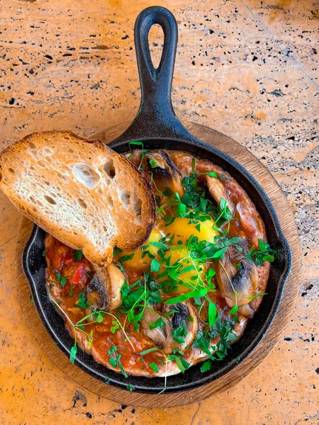 delicious shakshuka - fried eggs, onion, bell pepper, tomatoes, chili