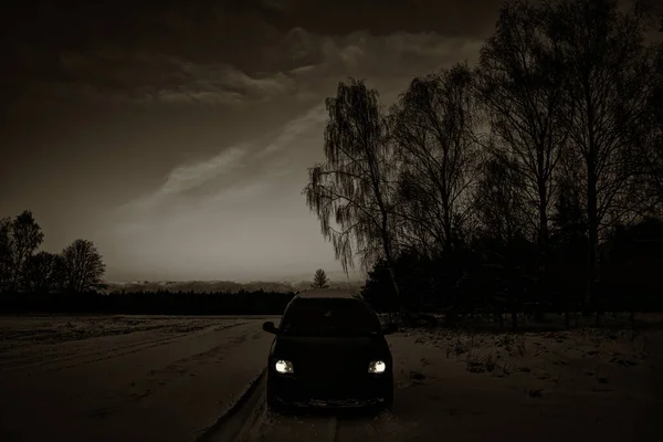 Black Car Headlights Snow Covered Slippery Forest Road Latvia Countryside — Stockfoto