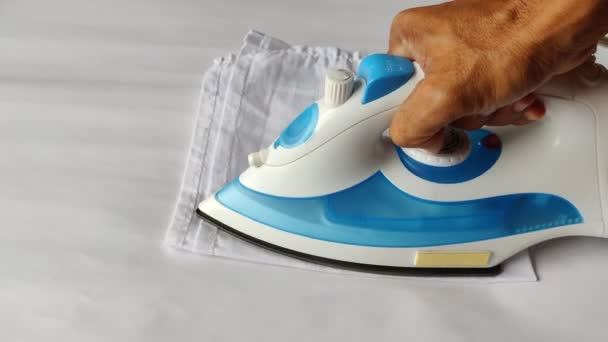 Ironing Cloth Using Iron Box Closeup Shot White Background — Stock Video