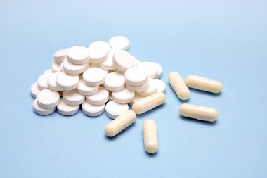 a lot of pills on a light blue background