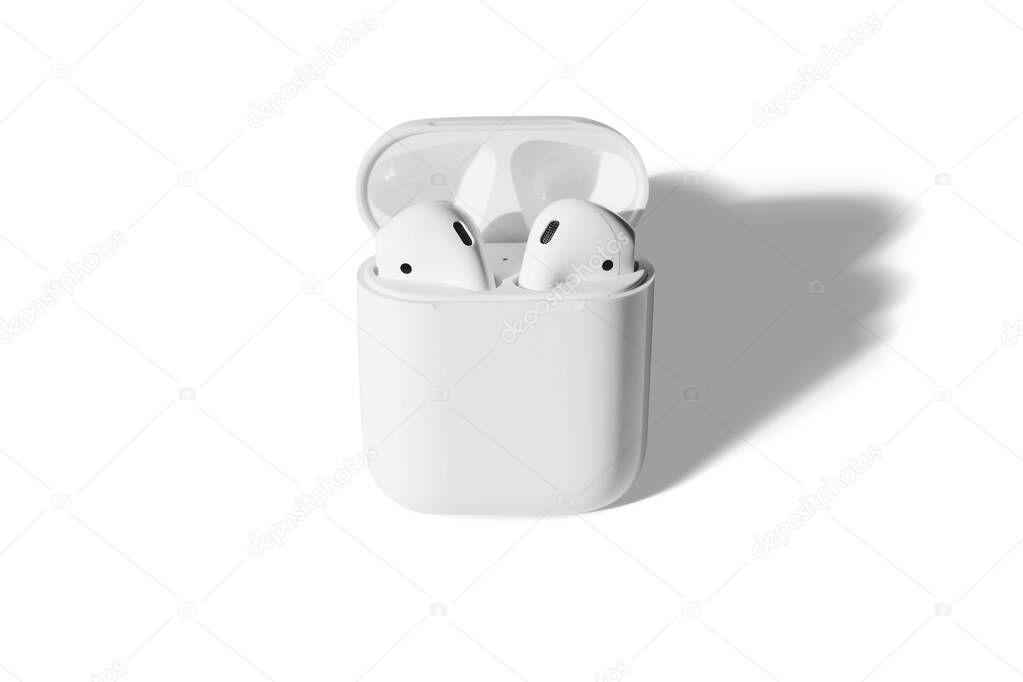 White wireless headphones mockup isolated on a white background. open white earphones case. 3d rendering.