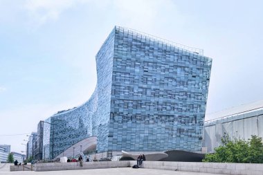 Blue glass facade of Le Monde Group headquarters building designed by Snohetta
