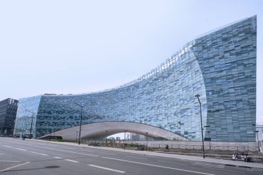 Blue glass facade of Le Monde Group headquarters building designed by Snohetta