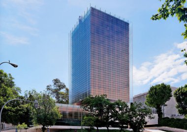 Madrid, Spain - May 2018: Low angle view of Castelar Tower in Castellana Avenue in Madrid against blue sky