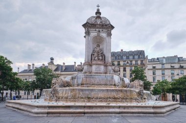 Paris, France - May, 2022: The Saint Sulpice fountain and Church of Saint Sulpice, in the Saint-Germain des Pres neighborhood