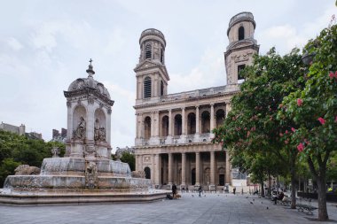 Paris, France - May, 2022: The Saint Sulpice fountain and Church of Saint Sulpice, in the Saint-Germain des Pres neighborhood