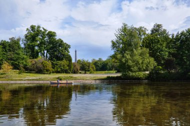 Paris, France - May, 2022: View of lower lake in the Bois de Boulogne and reflections of the nature