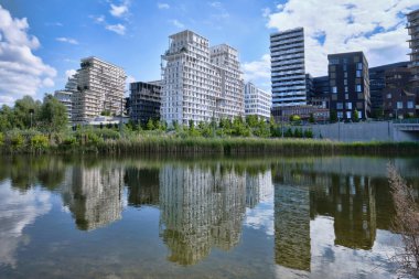 Paris, France - May, 2022: Parc Clichy Batignolles Eco Districtreflectios of New housing projects from Martin Luther King Park
