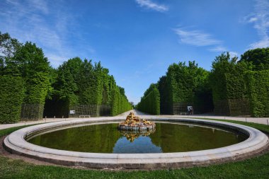Paris, France - May, 2022:  Gardens of the famous Palace of Versailles. whole site have unique fountains, ponds, lake and landscapes built in 17th century