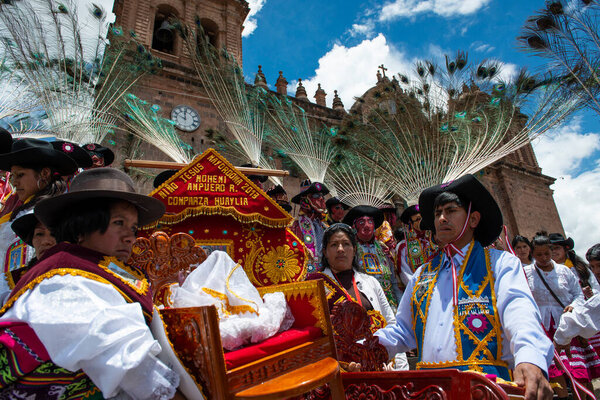 Cuzco, Peru - December 25, 2013: A group of people wearing traditional clothes and masks during the Huaylia on Christmas day in front of the Cuzco Cathedral in the city Cuzco, Peru.