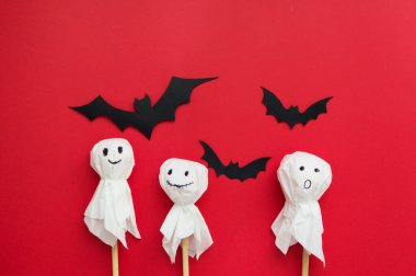 Cadılar Bayramı düzlüğü - kırmızı arka planda yarasalar ve balkabağı. Cadılar Bayramı için hediyeler ve alışveriş. Ders için yer. Tatiller ve sürprizler..