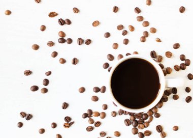 Beyaz arka planda bir fincan aromatik kahve ve dağınık kahve taneleri. Günaydın. Bir çeşit sveru. Düz yat. mesaj için yer. Kahve zamanı..