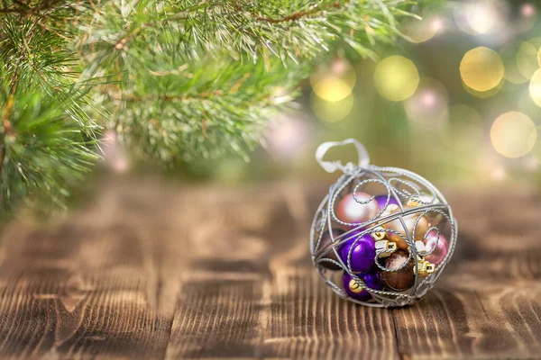 Christmas Ornament Lies Christmas Tree Wooden Surface Defocused Lights Background — Stock Photo, Image