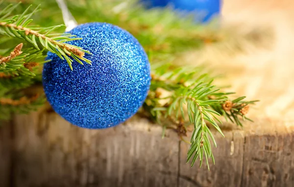 Blue Shiny Christmas Ornament Green Leaf Branch Wooden Background Stockbild